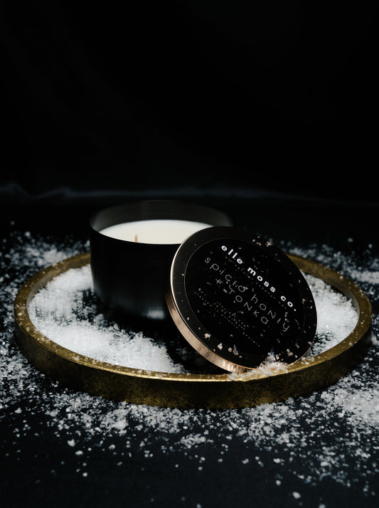 spiced honey + tonka in 17oz coconut soy wax candle in a brushed black aluminum vessel and gold lid by elle moss, co.