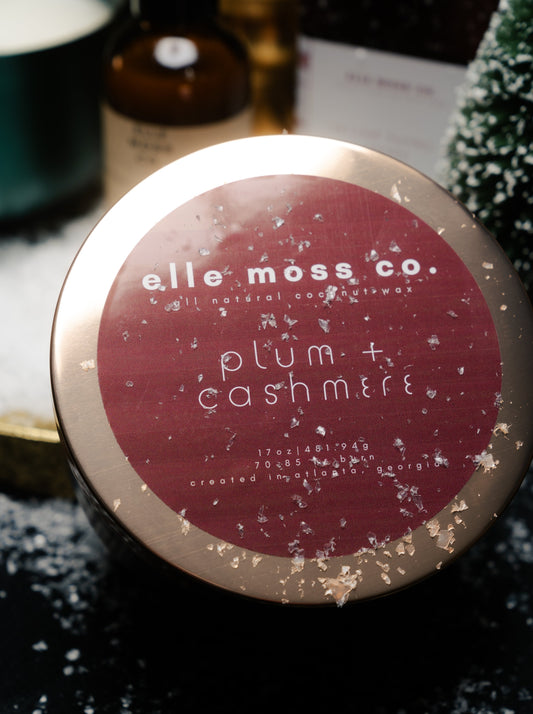 elle moss co. plum + cashmere 17oz candle in brushed plum aluminum vessel and gold lid.